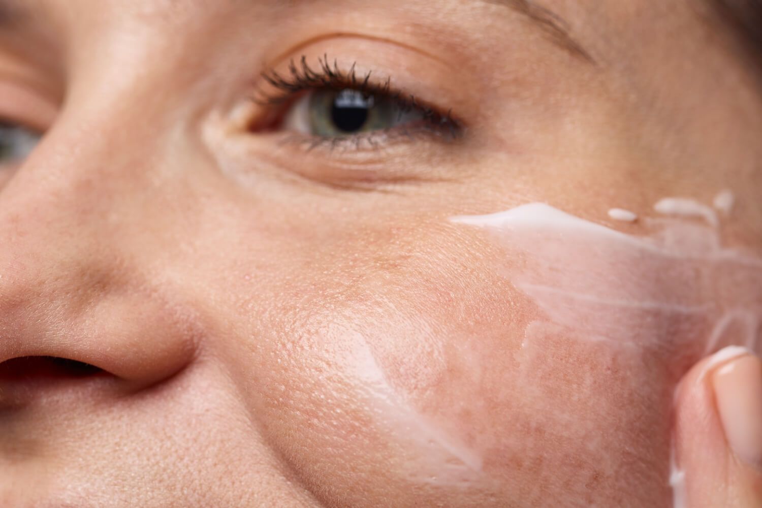 woman applying moisturizer