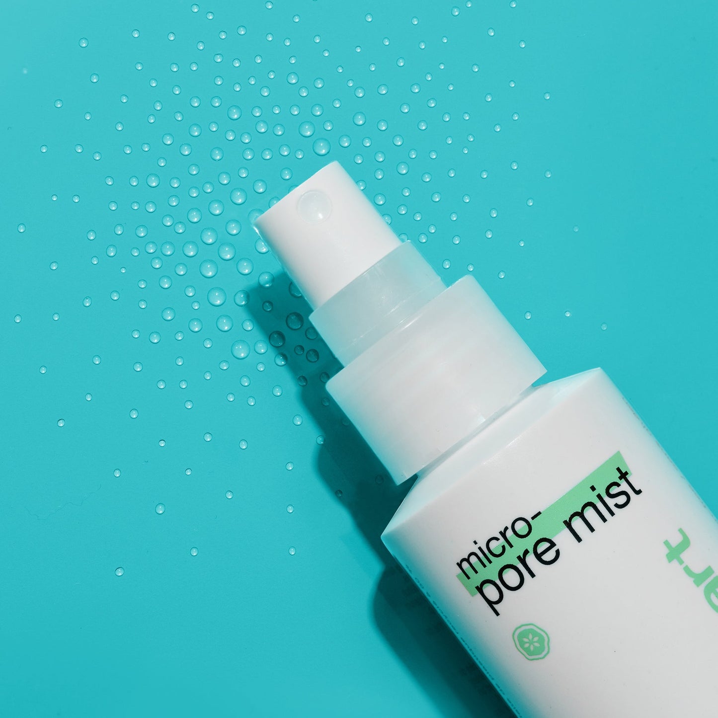 Micro-Pore Mist bottle with droplets on background 