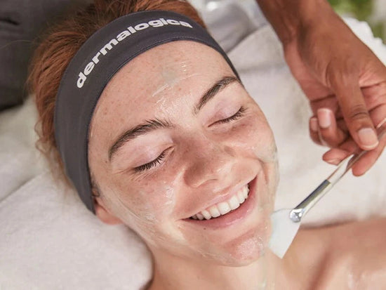 woman smiling receiving treatment with fan brush