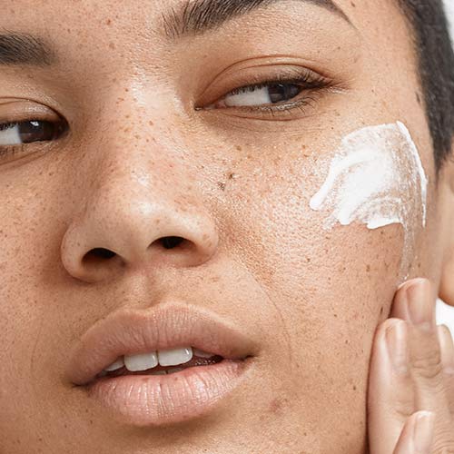 woman with moisturizer on face