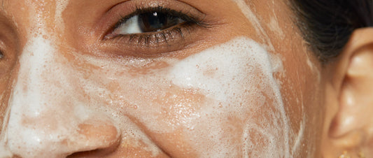 woman with cleanser on face