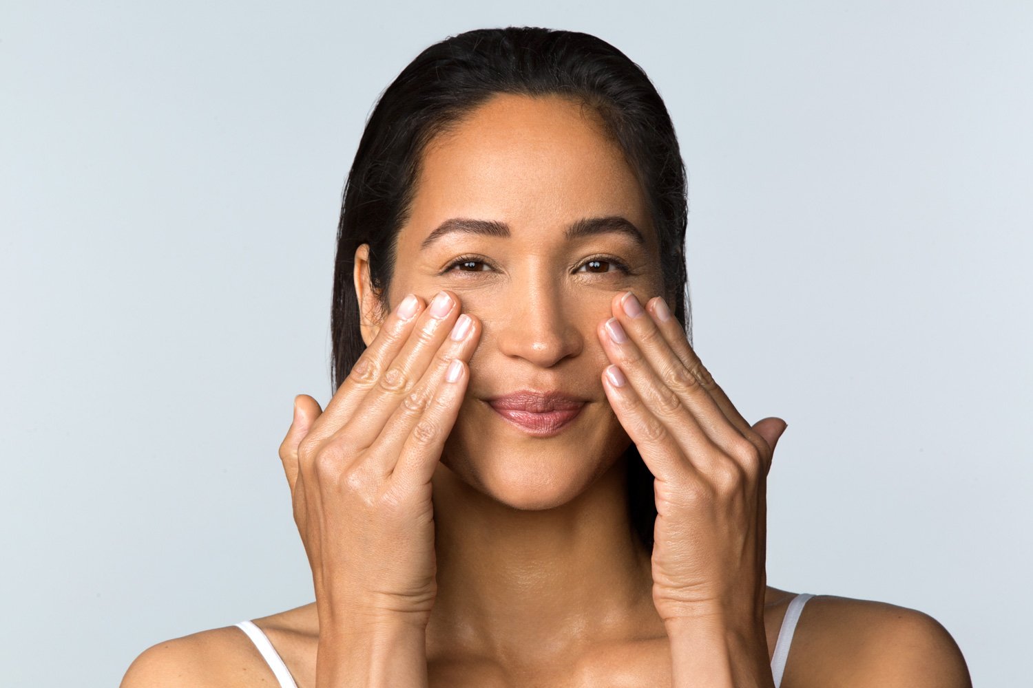 woman applying product to face
