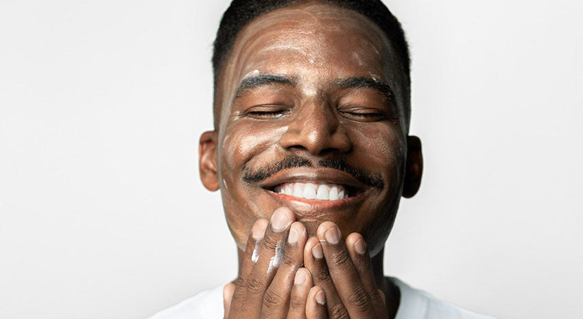 man applying product to face