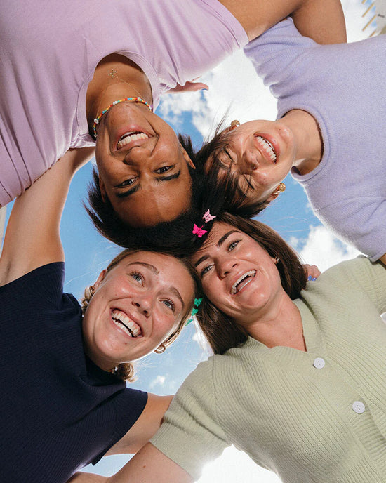 group of women in circle smiling