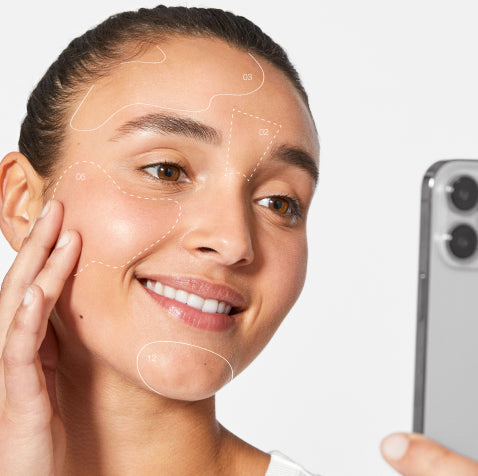 woman with face mapping shapes holding phone