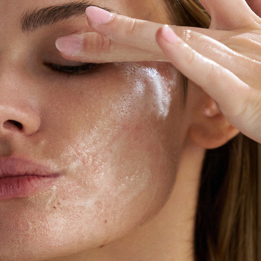 Dermalogica oil to foam cleanser bottle with text highlighting product features on a white background