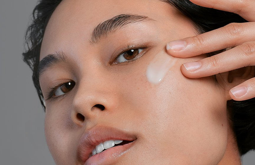 model applying product onto skin