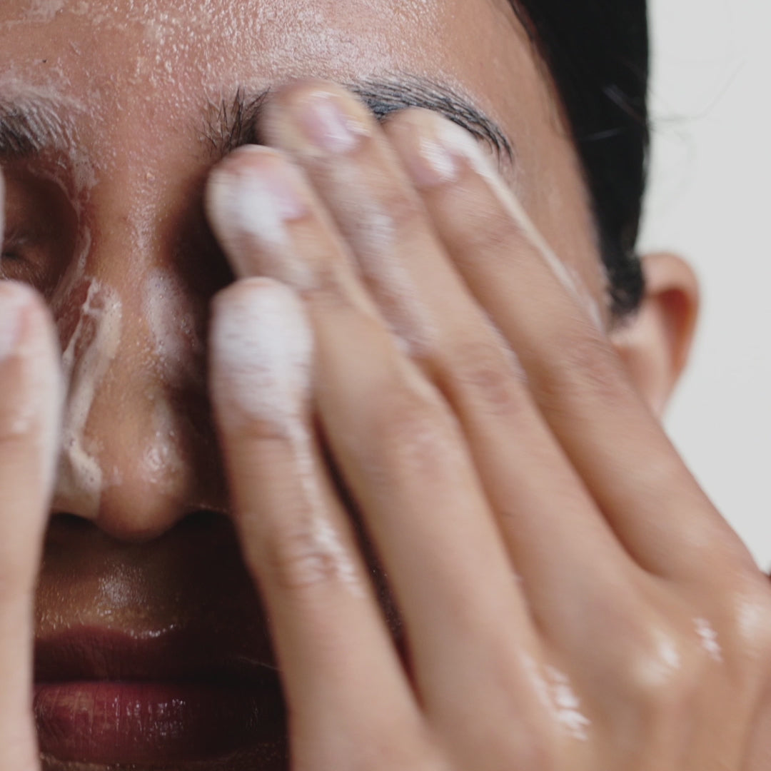 woman cleansing face with oil to foam total cleanser