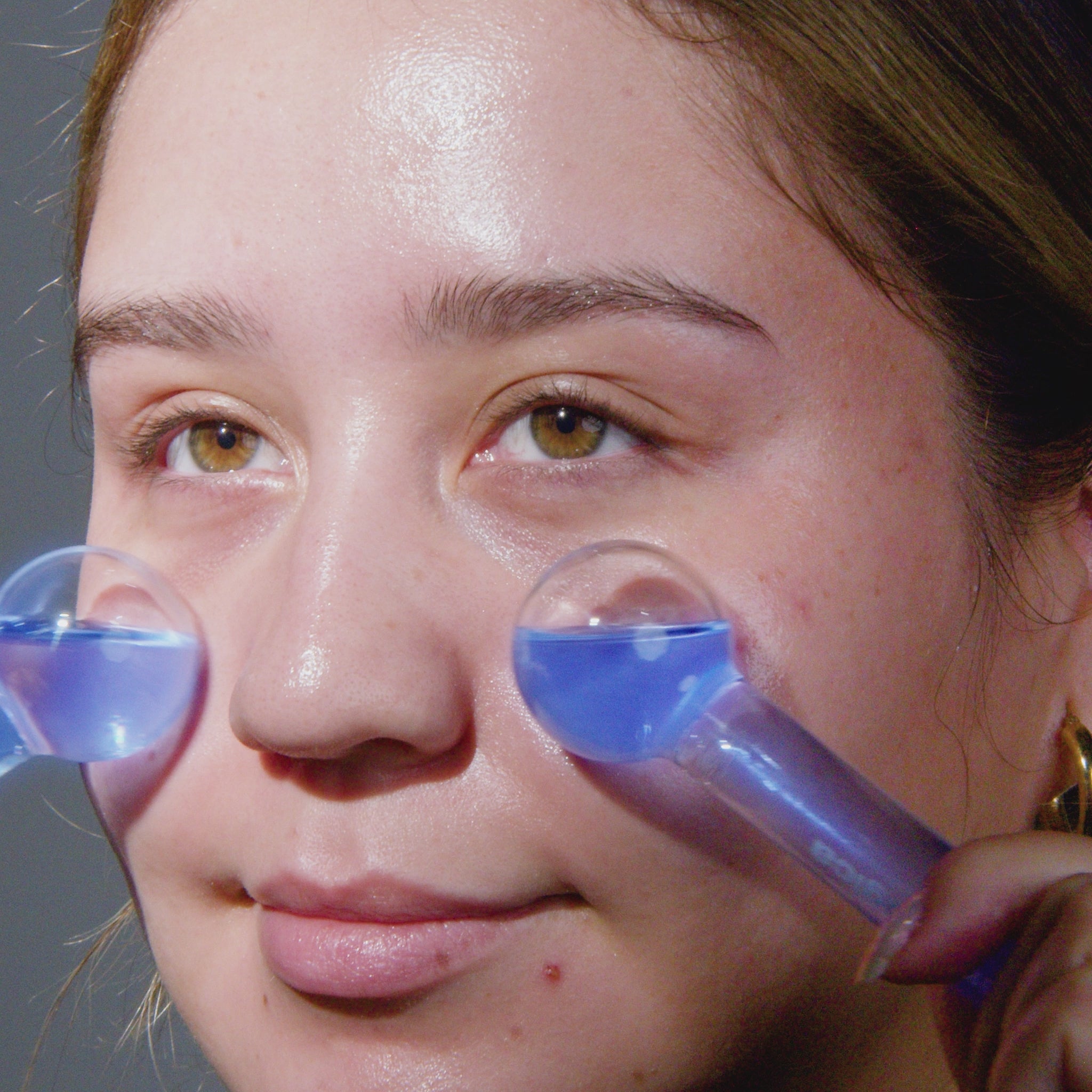 model using ice globes on face