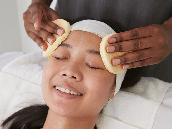 woman smiling receiving treatment with sponges