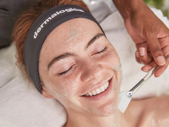 woman smiling receiving treatment with fan brush