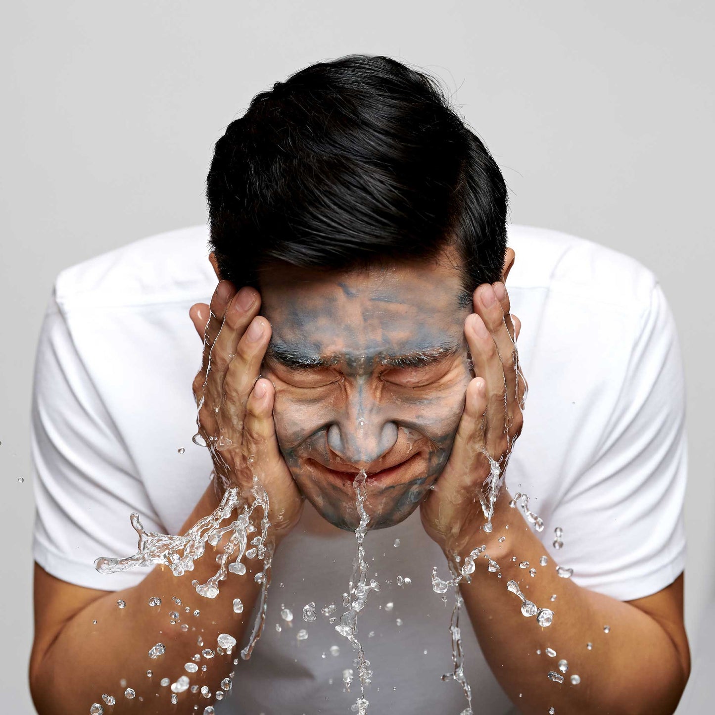man cleansing face with active clay cleanser 