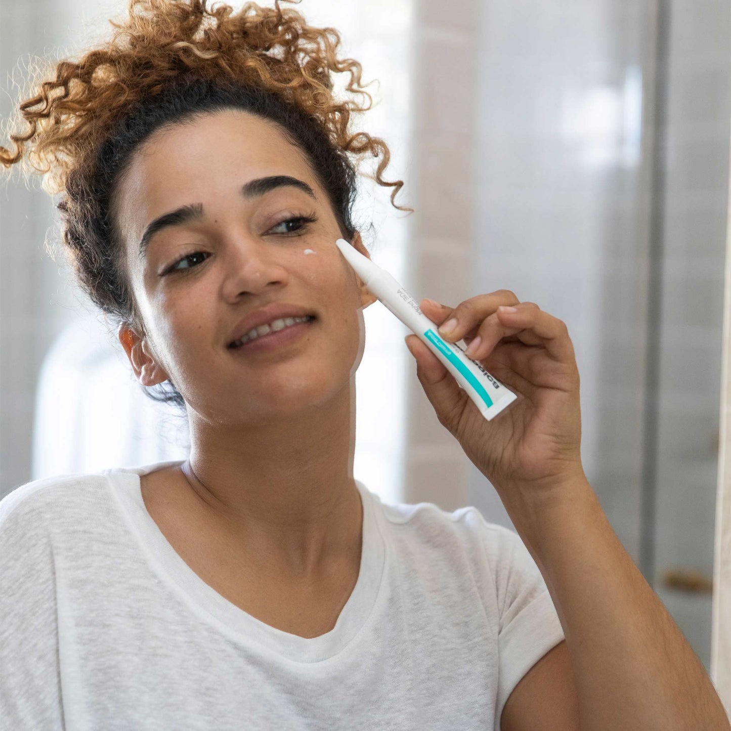 woman applying age bright spot fader 