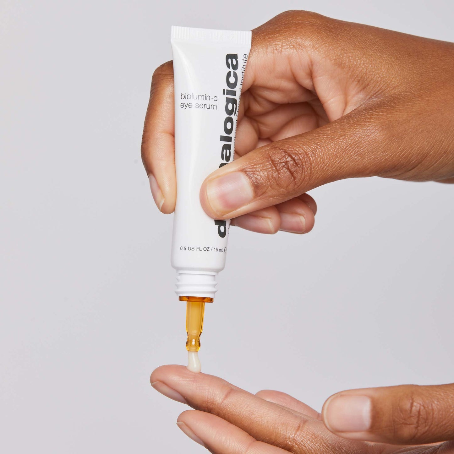 biolumin-c eye serum being dispensed onto fingertips