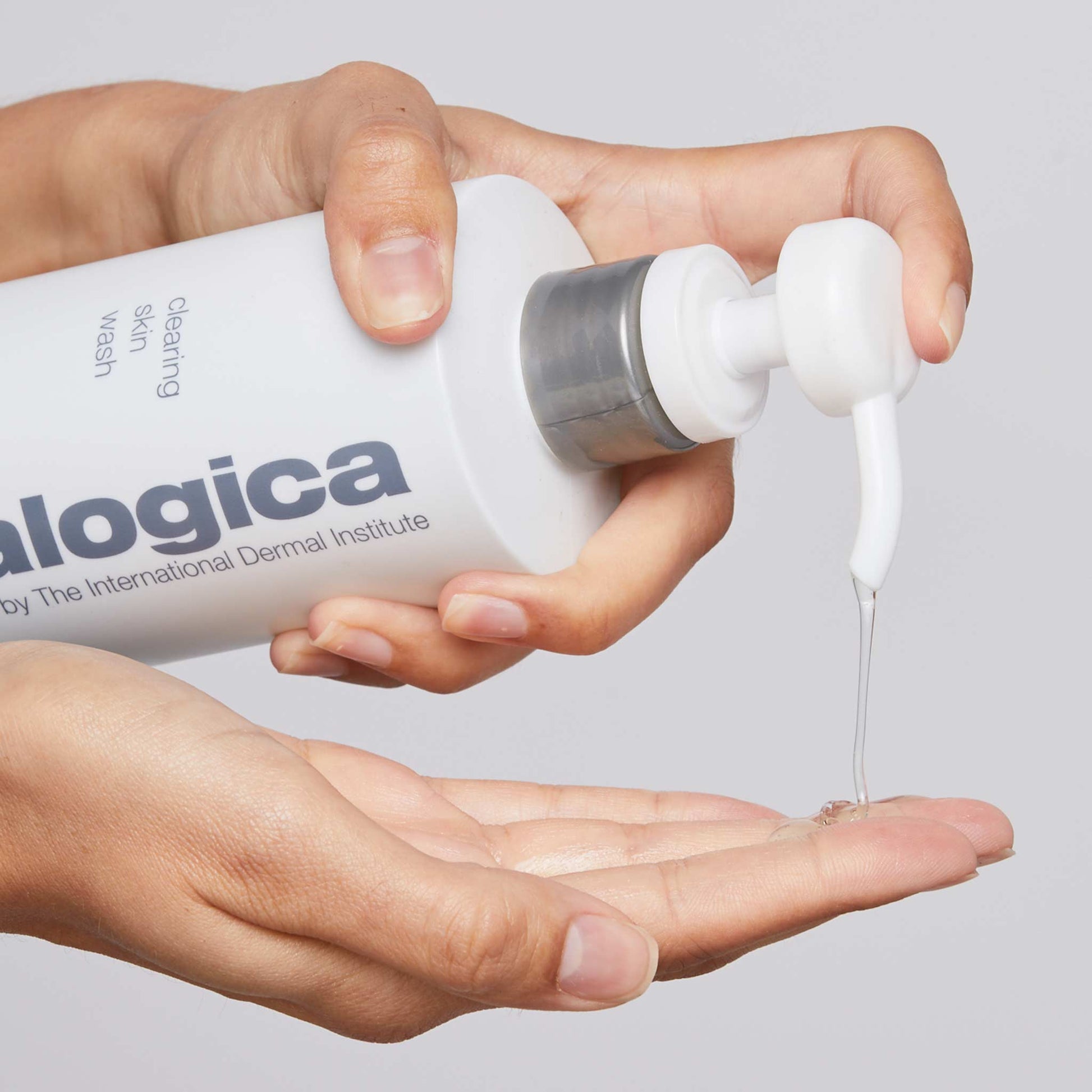 clearing skin wash being dispensed onto fingertips