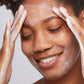 woman cleansing face with daily microfoliant