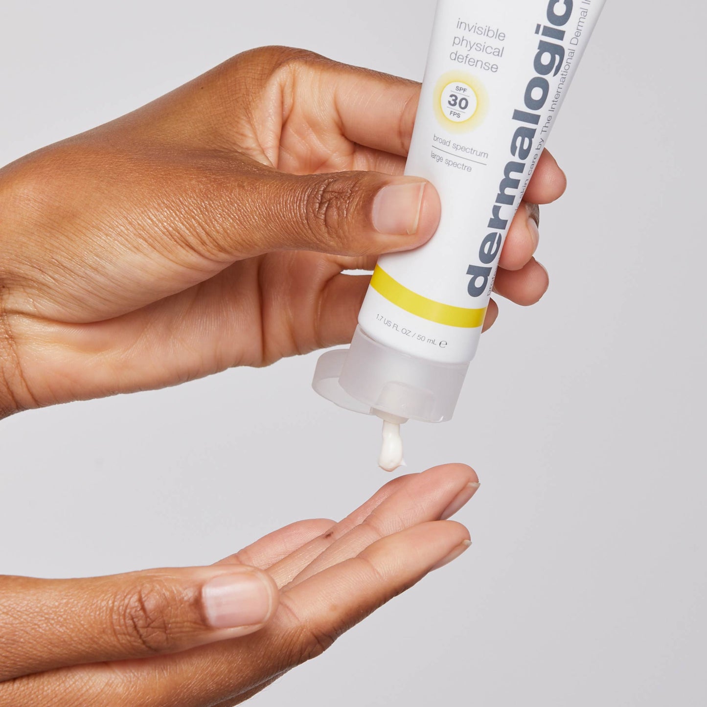 invisible physical defense spf30 being dispensed onto fingertip