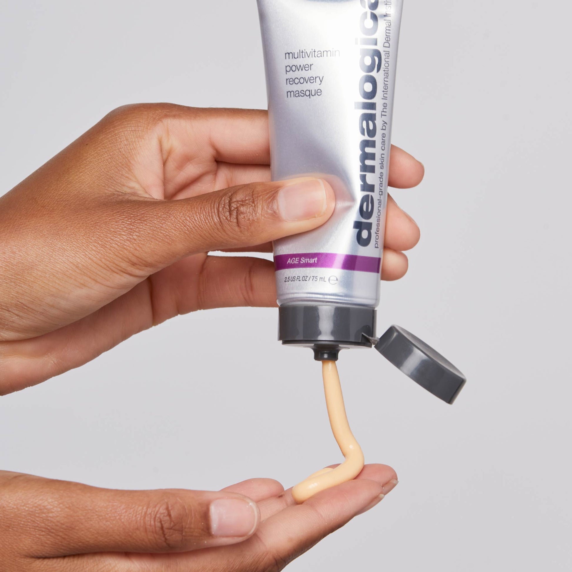 multivitamin power recovery masque being dispensed onto fingertip