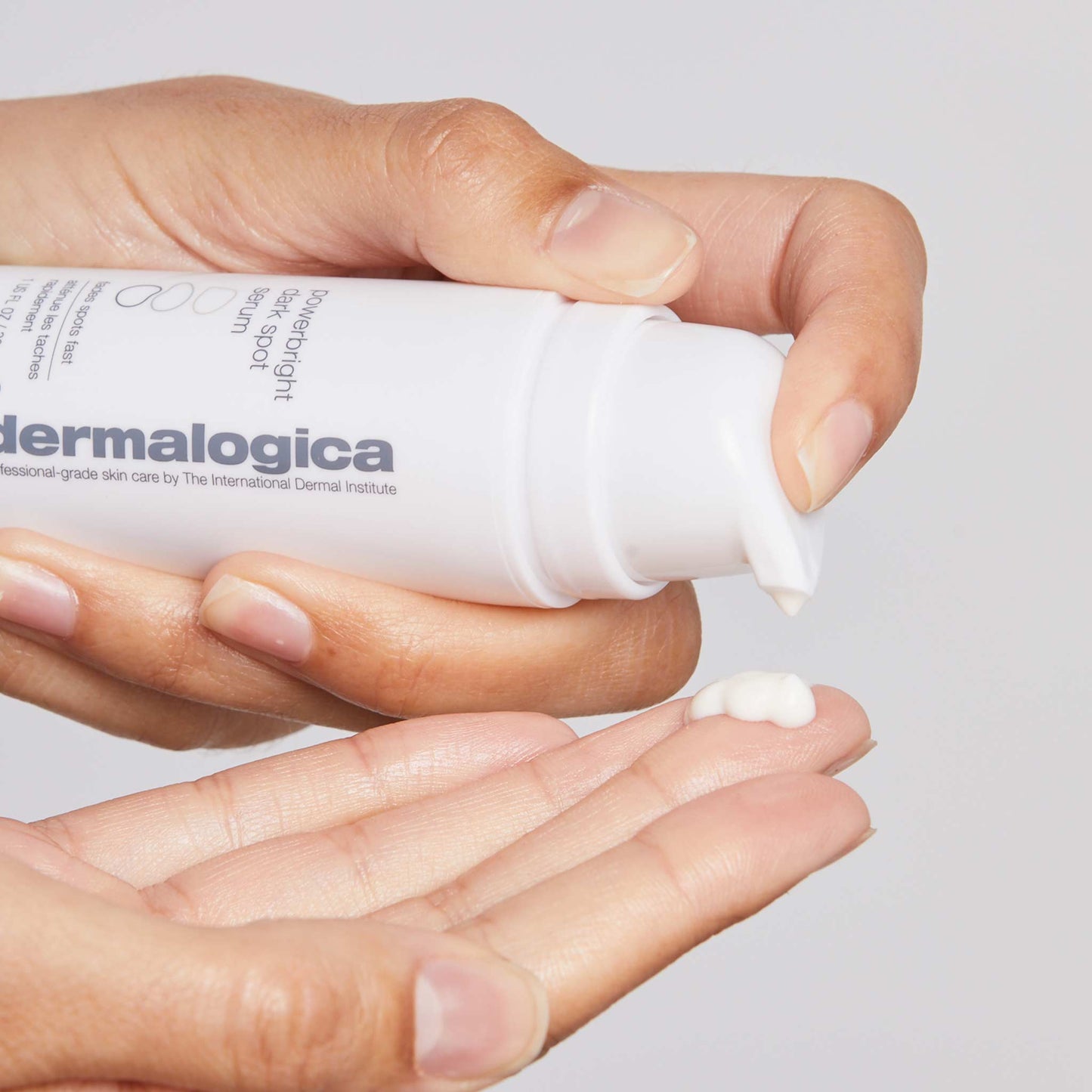 powerbright dark spot serum being dispensed onto fingertip 