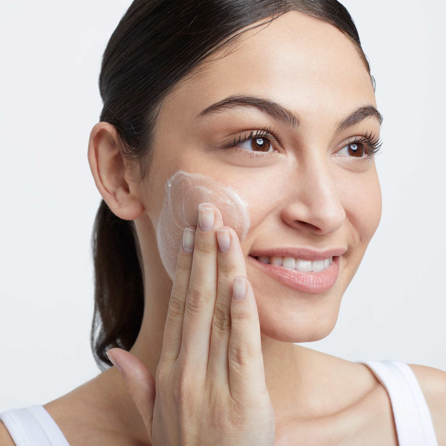woman applying precleanse balm 