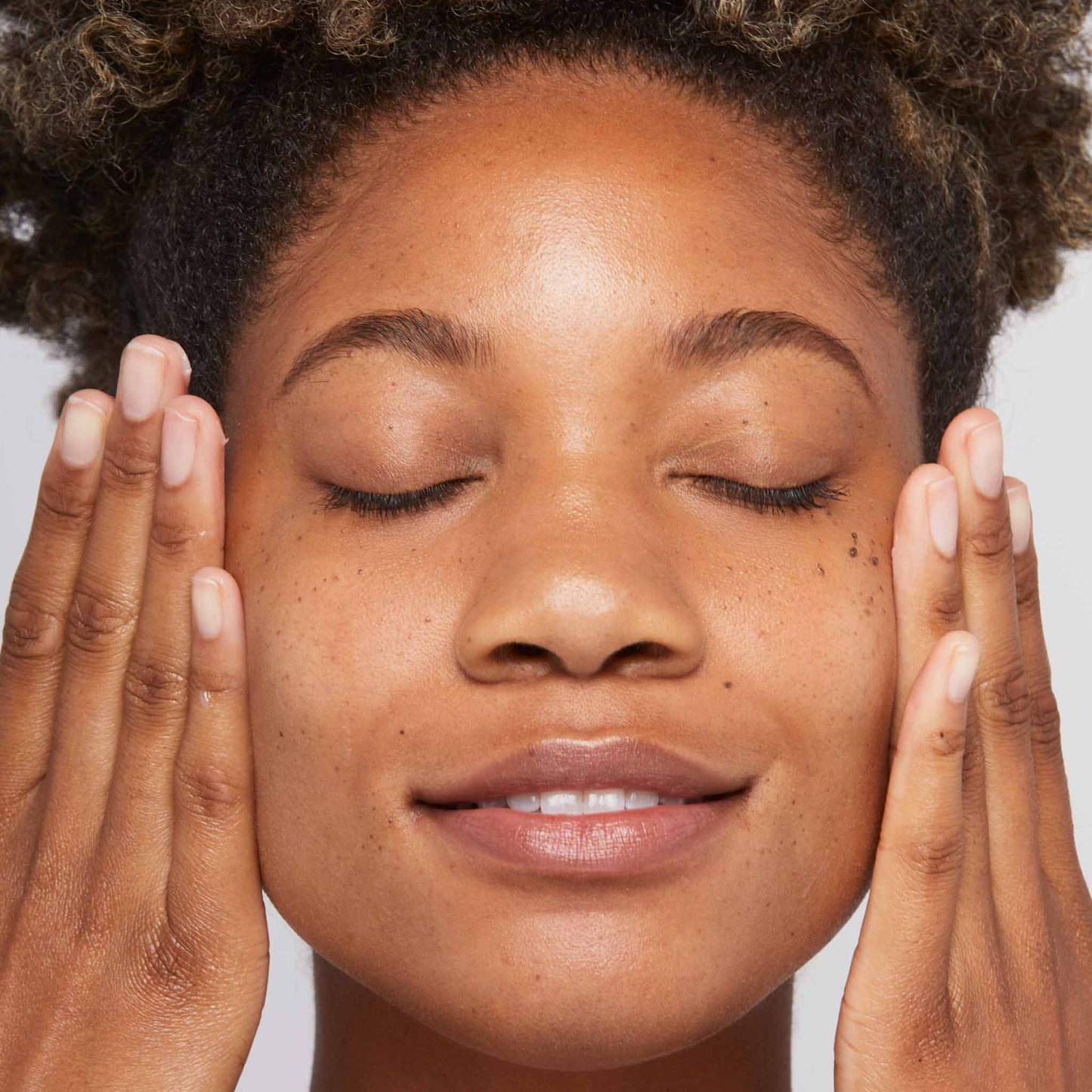 woman applying sound sleep cocoon onto face