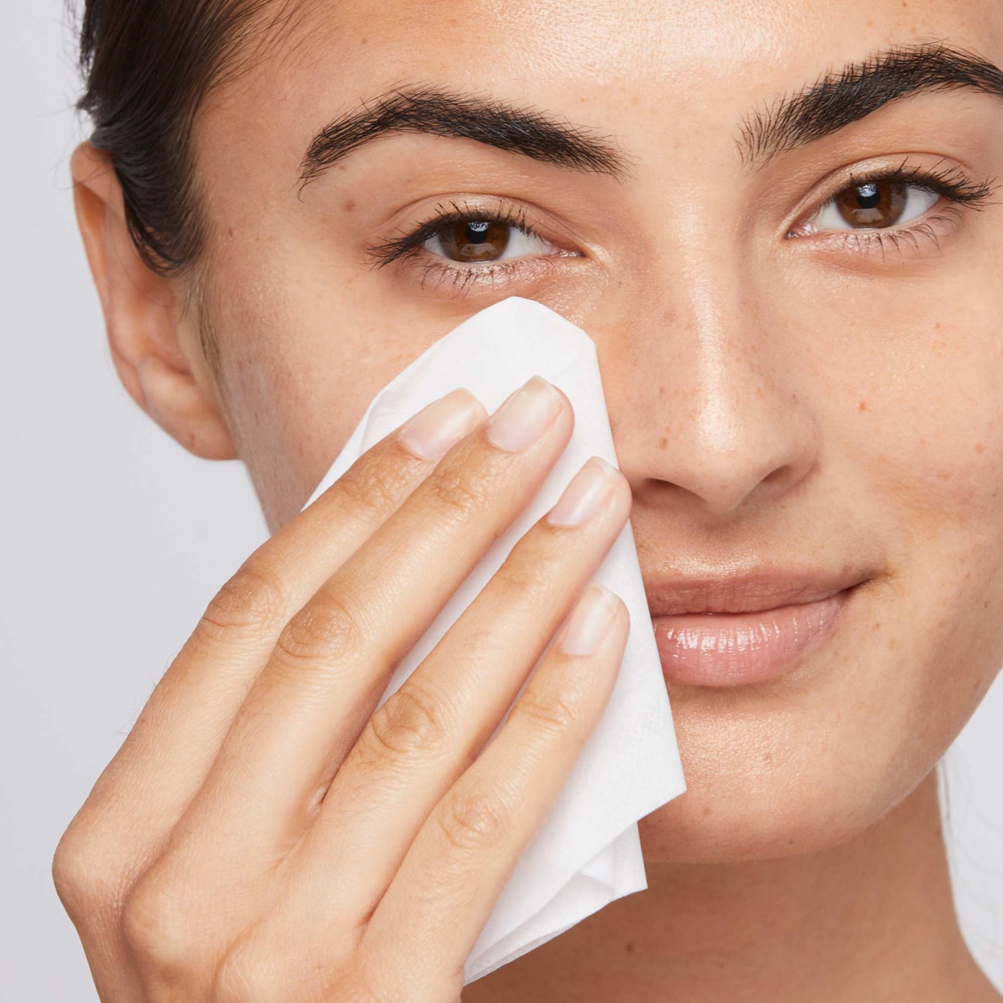 woman wiping off excess stress positive eye lift with tissue 