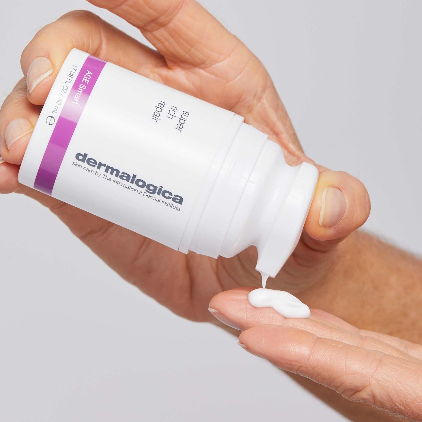 super rich repair being dispensed onto fingertips 