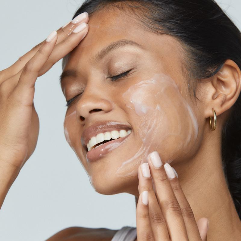 woman applying ultracalming cleanser