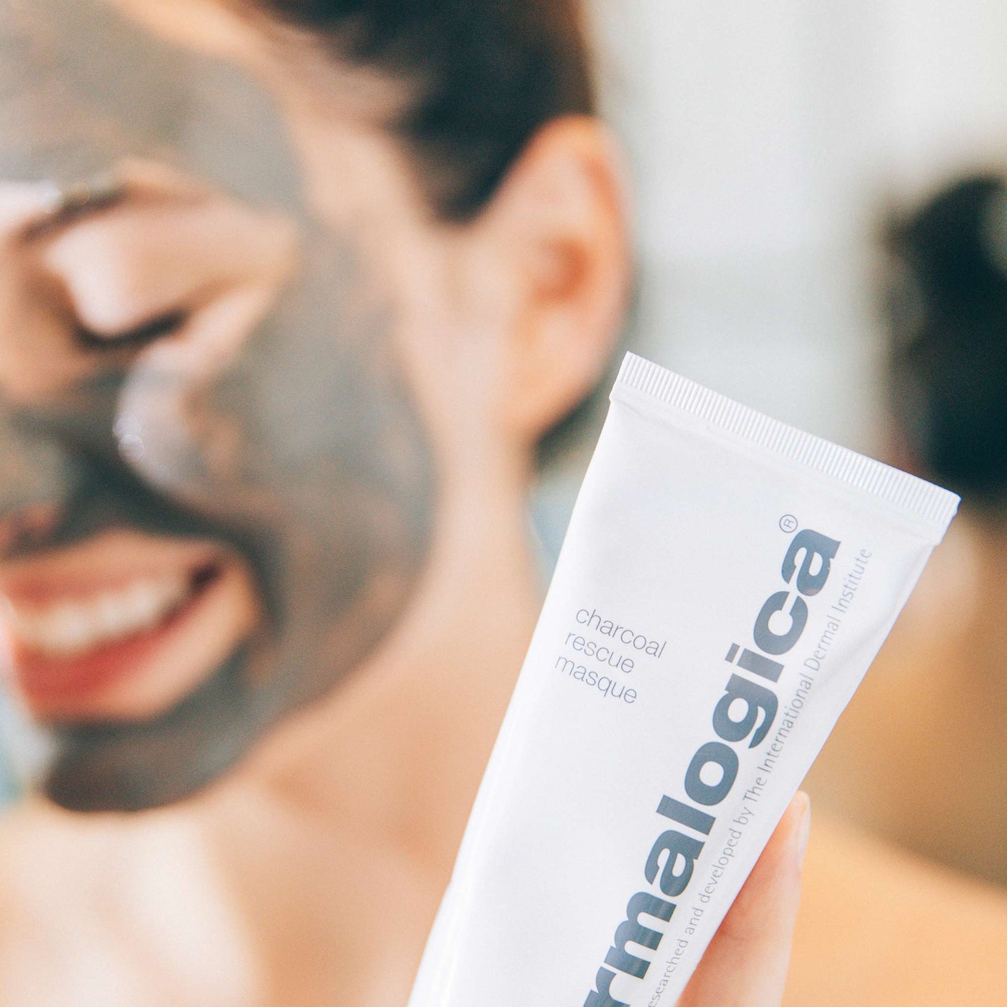 woman using charcoal rescue masque