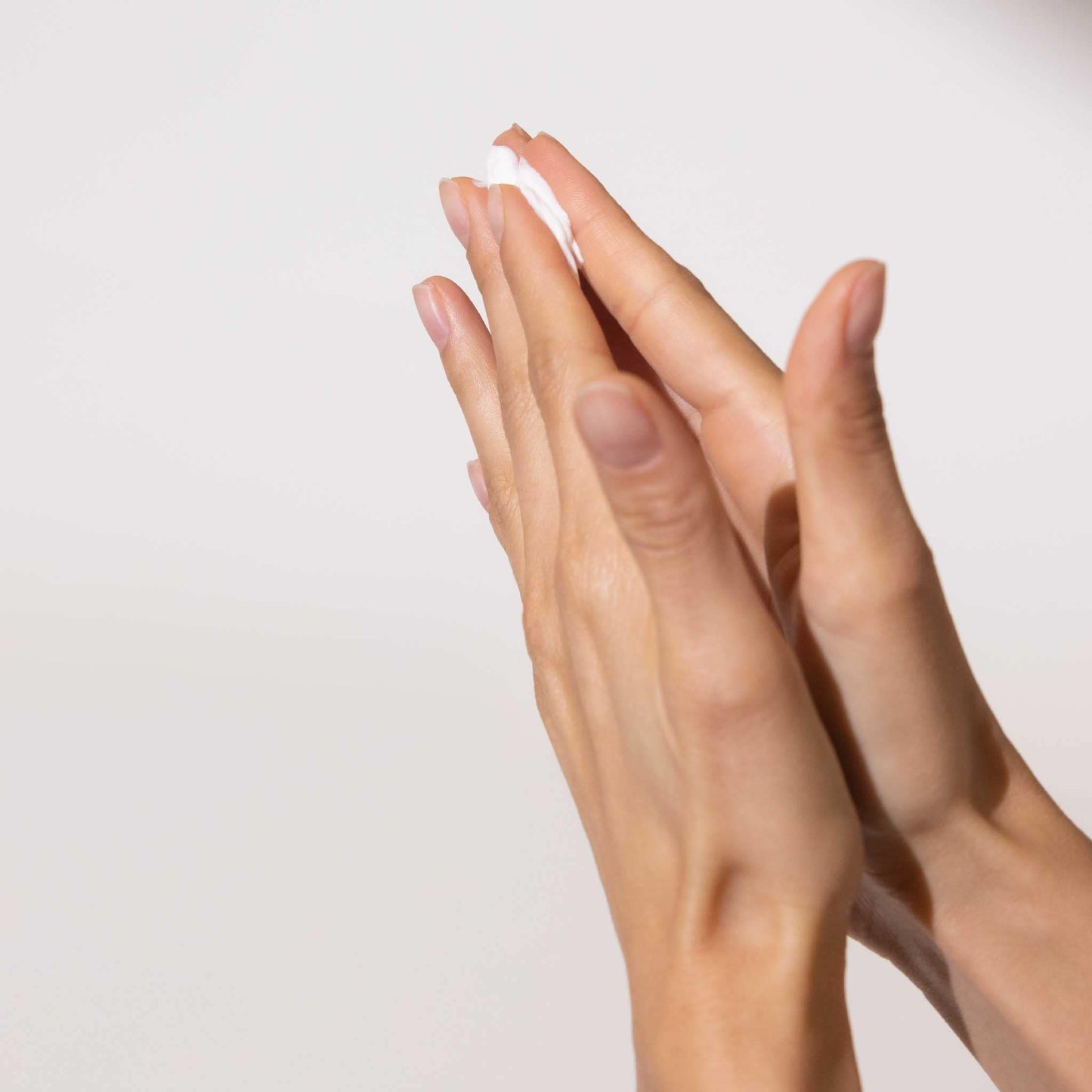 Hands with product in between fingertips