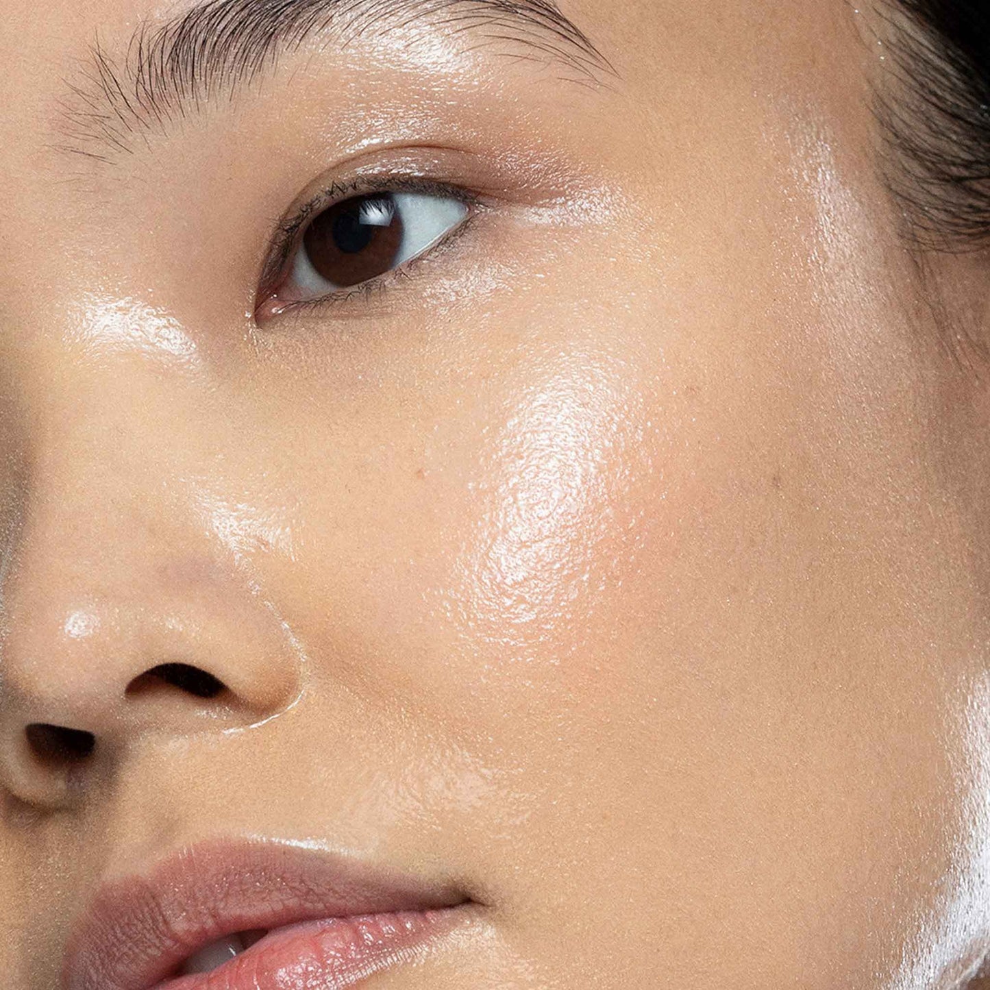 woman with hyaluronic ceramide mist spritzed onto face 