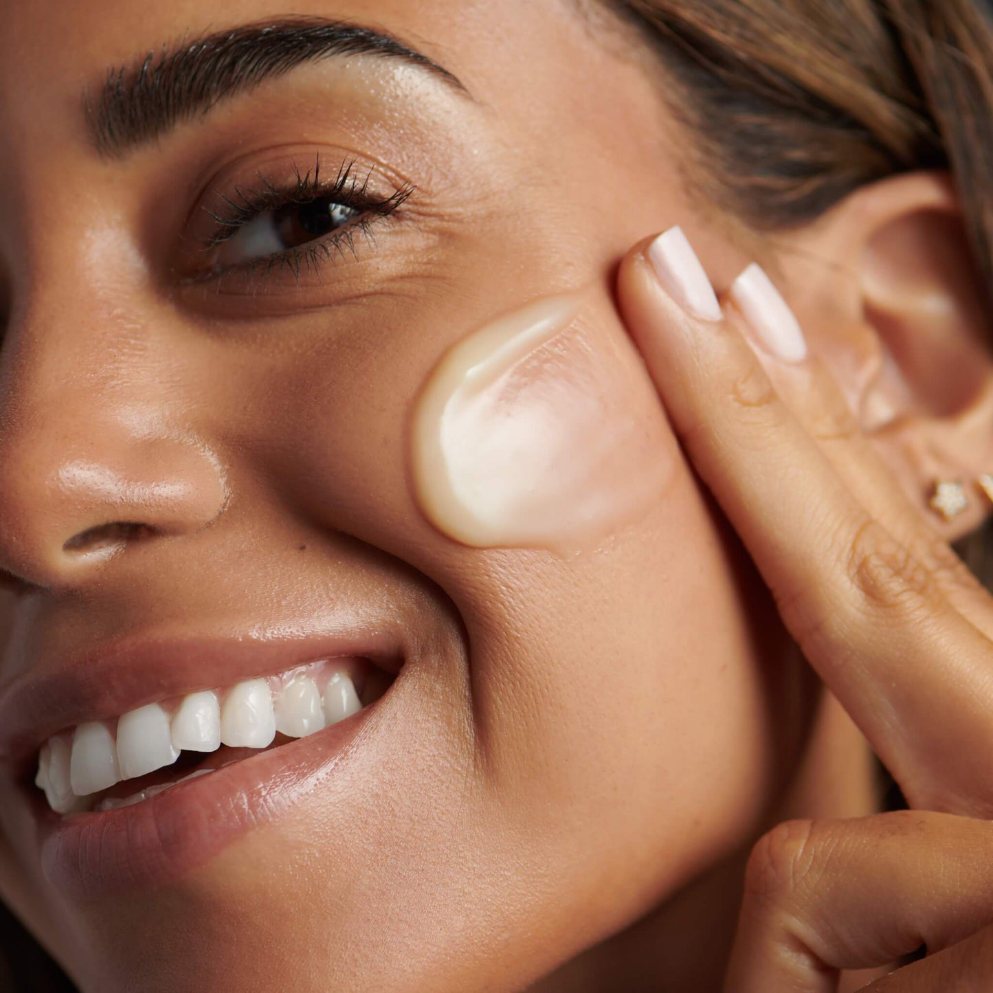 woman applying melting moisture masque onto face